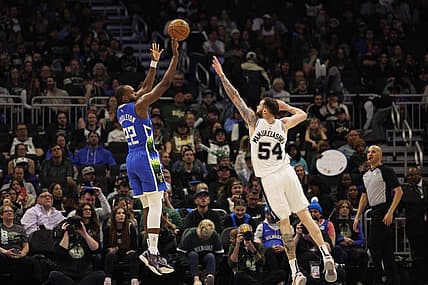 Mar 22, 2023; Milwaukee, Wisconsin, USA;  Milwaukee Bucks forward Khris Middleton (22) shoots against San Antonio Spurs forward Sandro Mamukelashvili (54) during the fourth quarter at Fiserv Forum. Mandatory Credit: Jeff Hanisch-USA TODAY Sports