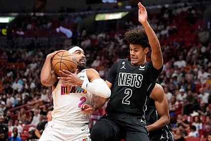 Mar 25, 2023; Miami, Florida, USA; Brooklyn Nets forward Cameron Johnson (2) fouls Miami Heat guard Gabe Vincent (2) during the first quarter at Miami-Dade Arena. Mandatory Credit: Rich Storry-USA TODAY Sports