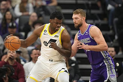 Mar 25, 2023; Sacramento, California, USA; Utah Jazz center Udoka Azubuike (left) dribbles against Sacramento Kings forward Domantas Sabonis (right) during the first quarter at Golden 1 Center. Mandatory Credit: Darren Yamashita-USA TODAY Sports
