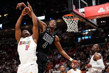 Mar 25, 2023; Miami, Florida, USA; Miami Heat guard Kyle Lowry (7) and Brooklyn Nets guard Edmond Sumner (4) compete for a rebound during the second half at Miami-Dade Arena. Mandatory Credit: Rich Storry-USA TODAY Sports