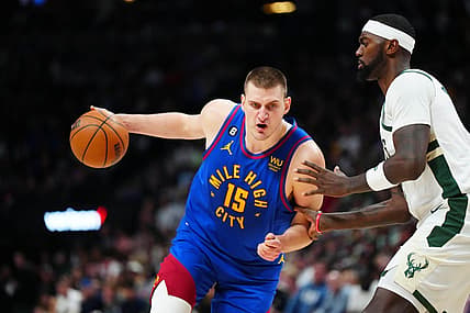 Mar 25, 2023; Denver, Colorado, USA; Denver Nuggets center Nikola Jokic (15) drives at Milwaukee Bucks forward Bobby Portis (9) during the second half at Ball Arena. Mandatory Credit: Ron Chenoy-USA TODAY Sports