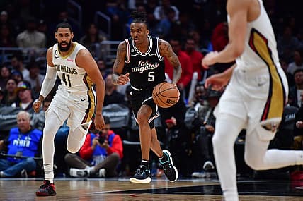 Mar 25, 2023; Los Angeles, California, USA; Los Angeles Clippers guard Bones Hyland (5) moves the ball ahead of New Orleans Pelicans forward Garrett Temple (41) during the second half at Crypto.com Arena. Mandatory Credit: Gary A. Vasquez-USA TODAY Sports