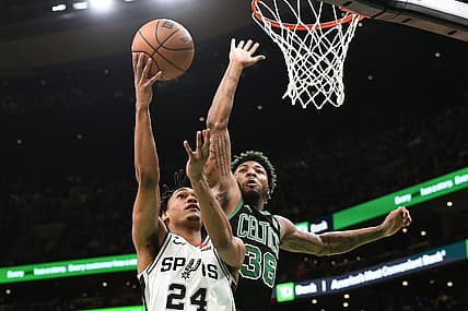 Mar 26, 2023; Boston, Massachusetts, USA; San Antonio Spurs guard Devin Vassell (24) attempts a layup against Boston Celtics guard Marcus Smart (36) during the first quarter at the TD Garden. Mandatory Credit: Brian Fluharty-USA TODAY Sports