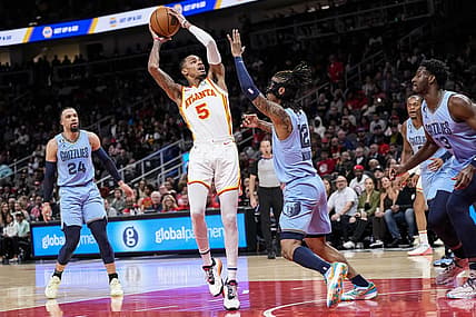 Mar 26, 2023; Atlanta, Georgia, USA; Atlanta Hawks guard Dejounte Murray (5) looks to shoot against Memphis Grizzlies guard Ja Morant (12) during the first half at State Farm Arena. Mandatory Credit: Dale Zanine-USA TODAY Sports
