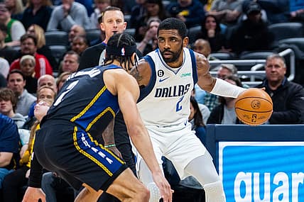 Mar 27, 2023; Indianapolis, Indiana, USA; Dallas Mavericks guard Kyrie Irving (2) dribbles the ball while Indiana Pacers guard Andrew Nembhard (2) defends in the first quarter at Gainbridge Fieldhouse. Mandatory Credit: Trevor Ruszkowski-USA TODAY Sports