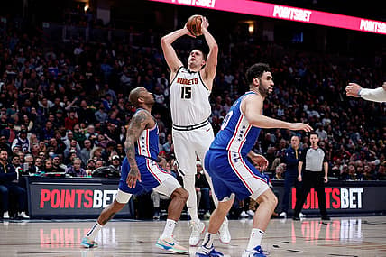 Mar 27, 2023; Denver, Colorado, USA; Denver Nuggets center Nikola Jokic (15) attempts a shot against Philadelphia 76ers forward P.J. Tucker (17) as forward Georges Niang (20) defends in the second quarter at Ball Arena. Mandatory Credit: Isaiah J. Downing-USA TODAY Sports