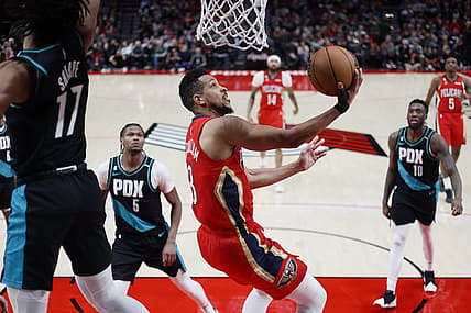 Mar 27, 2023; Portland, Oregon, USA; New Orleans Pelicans shooting guard CJ McCollum (3, right) shoots the ball past Portland Trail Blazers shooting guard Shaedon Sharpe (17) during the second half at Moda Center. Mandatory Credit: Soobum Im-USA TODAY Sports