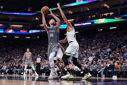 Mar 27, 2023; Sacramento, California, USA; Sacramento Kings forward Domantas Sabonis (10) shoots the ball next to Minnesota Timberwolves center Rudy Gobert (27) in the fourth quarter at the Golden 1 Center. Mandatory Credit: Cary Edmondson-USA TODAY Sports