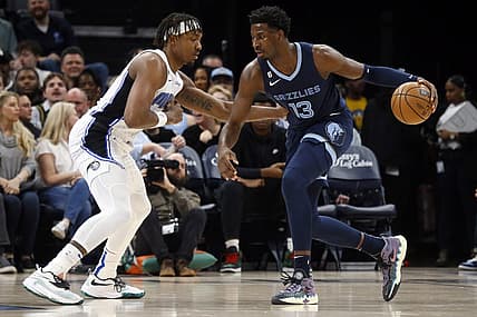Mar 28, 2023; Memphis, Tennessee, USA; Memphis Grizzlies forward Jaren Jackson Jr. (13) dribbles to the basket as Orlando Magic center Wendell Carter Jr. (34) defends during the first half at FedExForum. Mandatory Credit: Petre Thomas-USA TODAY Sports
