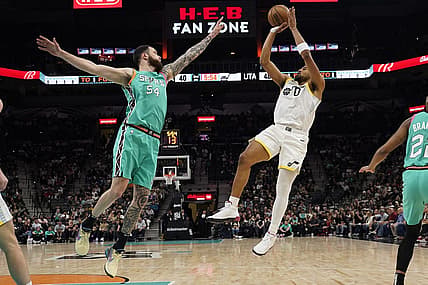 Mar 29, 2023; San Antonio, Texas, USA; Utah Jazz forward Talen Horton-Tucker (0) shoots over San Antonio Spurs forward Sandro Mamukelashvili (54) during the first half at AT&T Center. Mandatory Credit: Scott Wachter-USA TODAY Sports