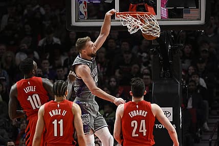 Mar 29, 2023; Portland, Oregon, USA; Sacramento Kings forward Domantas Sabonis (10) dunks the basketball during the first half against Portland Trail Blazers forward Nassir Little (10) at Moda Center. Mandatory Credit: Troy Wayrynen-USA TODAY Sports