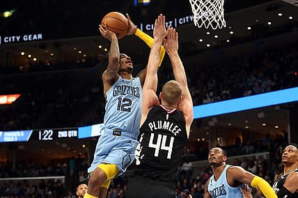 Mar 29, 2023; Memphis, Tennessee, USA; Memphis Grizzlies guard Ja Morant (12) shoots as Los Angeles Clippers center Mason Plumlee (44) defends during the first half at FedExForum. Mandatory Credit: Petre Thomas-USA TODAY Sports