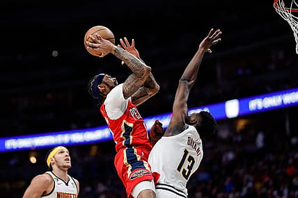 Mar 30, 2023; Denver, Colorado, USA; New Orleans Pelicans forward Brandon Ingram (14) drives to the net against Denver Nuggets center Thomas Bryant (13) in the first quarter at Ball Arena. Mandatory Credit: Isaiah J. Downing-USA TODAY Sports