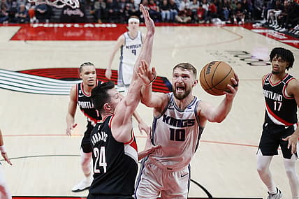 Mar 31, 2023; Portland, Oregon, USA; Sacramento Kings power forward Domantas Sabonis (10) shoots the ball against Portland Trail Blazers power forward Drew Eubanks (24) during the first half at Moda Center. Mandatory Credit: Soobum Im-USA TODAY Sports