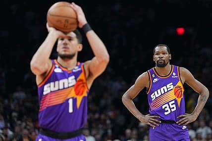 Mar 31, 2023; Phoenix, Arizona, USA; Phoenix Suns forward Kevin Durant (35) watches as Phoenix Suns guard Devin Booker (1) shoots a free throw against the Denver Nuggets during the first half at Footprint Center. Mandatory Credit: Joe Camporeale-USA TODAY Sports