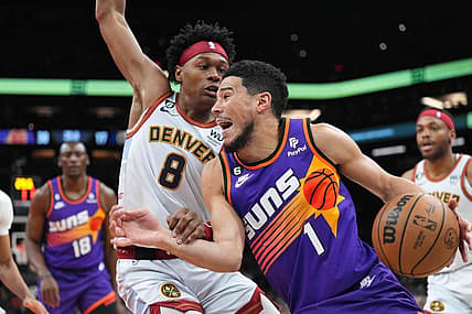 Mar 31, 2023; Phoenix, Arizona, USA; Phoenix Suns guard Devin Booker (1) dribbles against Denver Nuggets forward Peyton Watson (8) during the first half at Footprint Center. Mandatory Credit: Joe Camporeale-USA TODAY Sports
