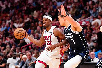 Apr 1, 2023; Miami, Florida, USA; Miami Heat forward Jimmy Butler (22) throws a pass against Dallas Mavericks center Dwight Powell (7) during the second quarter at Miami-Dade Arena. Mandatory Credit: Rich Storry-USA TODAY Sports