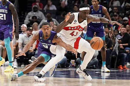 Apr 2, 2023; Charlotte, North Carolina, USA; Charlotte Hornets guard Theo Maledon (9) tries for a steal against Toronto Raptors forward Pascal Siakam (43) during second half at Spectrum Center. Mandatory Credit: Jim Dedmon-USA TODAY Sports