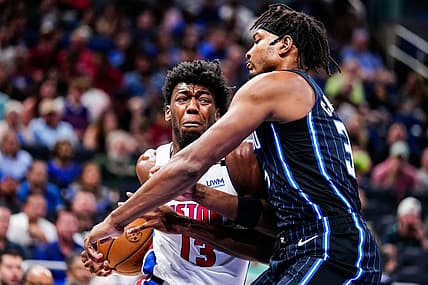 Apr 2, 2023; Orlando, Florida, USA; Detroit Pistons center James Wiseman (13) dribbles the ball past Orlando Magic forward Chuma Okeke (3) during the first quarter at Amway Center. Mandatory Credit: Rich Storry-USA TODAY Sports