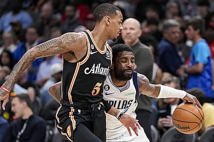 Apr 2, 2023; Atlanta, Georgia, USA; Dallas Mavericks guard Kyrie Irving (2) tries to dribble past Atlanta Hawks guard Dejounte Murray (5) during the first half at State Farm Arena. Mandatory Credit: Dale Zanine-USA TODAY Sports