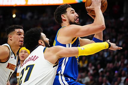 Apr 2, 2023; Denver, Colorado, USA; Golden State Warriors guard Klay Thompson (11) shoots past Denver Nuggets guard Jamal Murray (27) in the second quarter at Ball Arena. Mandatory Credit: Ron Chenoy-USA TODAY Sports