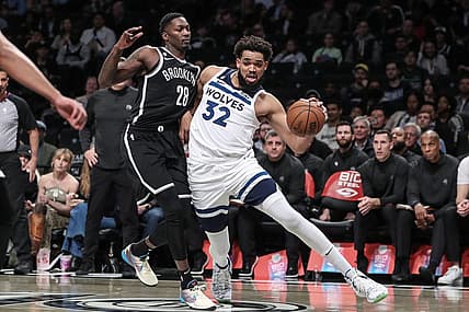 Apr 4, 2023; Brooklyn, New York, USA;  Minnesota Timberwolves center Karl-Anthony Towns (32) looks to drive past Brooklyn Nets forward Dorian Finney-Smith (28) in the first quarter at Barclays Center. Mandatory Credit: Wendell Cruz-USA TODAY Sports