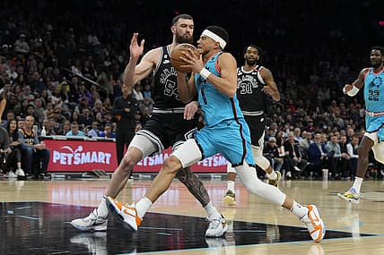 Apr 4, 2023; Phoenix, Arizona, USA; Phoenix Suns guard Devin Booker (1) drives on San Antonio Spurs forward Sandro Mamukelashvili (54) in the first half at Footprint Center. Mandatory Credit: Rick Scuteri-USA TODAY Sports