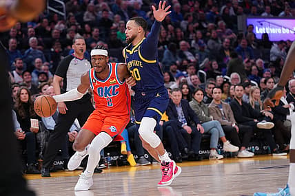 Apr 4, 2023; San Francisco, California, USA; Oklahoma City Thunder guard Shai Gilgeous-Alexander (2) dribbles the ball next to Golden State Warriors guard Stephen Curry (30) in the second quarter at the Chase Center. Mandatory Credit: Cary Edmondson-USA TODAY Sports