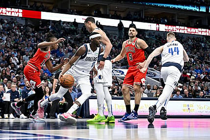 Apr 7, 2023; Dallas, Texas, USA; Dallas Mavericks forward Justin Holiday (0) grabs a rebound against the Chicago Bulls during the first quarter at the American Airlines Center. Mandatory Credit: Jerome Miron-USA TODAY Sports