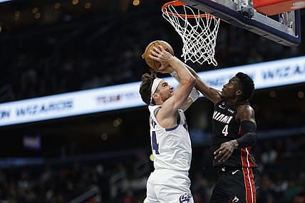 Apr 7, 2023; Washington, District of Columbia, USA; Washington Wizards forward Corey Kispert (24) is fouled while shooting the ball by Miami Heat guard Victor Oladipo (4) in the fourth quarter at Capital One Arena. Mandatory Credit: Geoff Burke-USA TODAY Sports