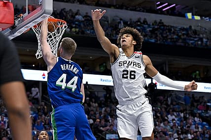 Apr 9, 2023; Dallas, Texas, USA; Dallas Mavericks forward Davis Bertans (44) dunks the ball past San Antonio Spurs forward Dominick Barlow (26) during the second quarter at the American Airlines Center. Mandatory Credit: Jerome Miron-USA TODAY Sports