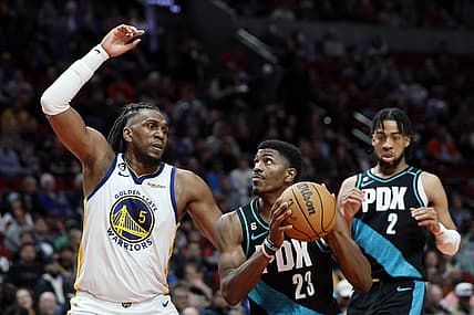 Apr 9, 2023; Portland, Oregon, USA; Portland Trail Blazers forward Jeenathan Williams (23) attempts to score as Golden State Warriors forward Kevon Looney (5) defends during the second half at Moda Center. Mandatory Credit: Soobum Im-USA TODAY Sports