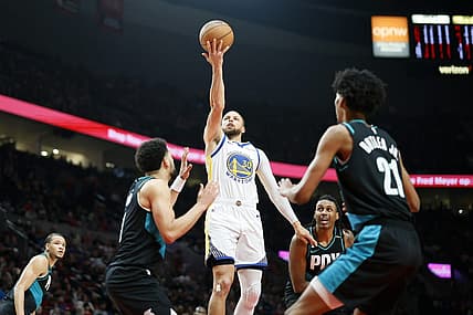 Apr 9, 2023; Portland, Oregon, USA; Golden State Warriors point guard Stephen Curry (30) shoots the ball against Portland Trail Blazers guard Skylar Mays (8, left) and  forward John Butler Jr. (21) during the first half at Moda Center. Mandatory Credit: Soobum Im-USA TODAY Sports