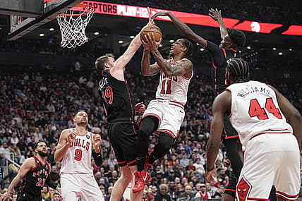 Apr 12, 2023; Toronto, Ontario, CAN; Toronto Raptors center Jakob Poeltl (19) and forward Chris Boucher (25) block a shot attempt by Chicago Bulls forward DeMar DeRozan (11) during the NBA Play-In game at Scotiabank Arena. Mandatory Credit: John E. Sokolowski-USA TODAY Sports