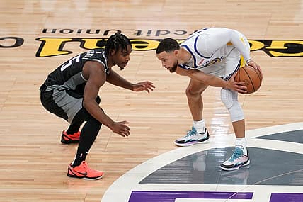 Apr 15, 2023; Sacramento, California, USA; Golden State Warriors guard Stephen Curry (30) holds onto the ball next to Sacramento Kings guard Davion Mitchell (15) in the second quarter during game one of the 2023 NBA playoffs at the Golden 1 Center. Mandatory Credit: Cary Edmondson-USA TODAY Sports