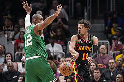 Apr 21, 2023; Atlanta, Georgia, USA; Atlanta Hawks guard Trae Young (11) passes behind Boston Celtics center Al Horford (42) during the first half during game three of the 2023 NBA playoffs at State Farm Arena. Mandatory Credit: Dale Zanine-USA TODAY Sports