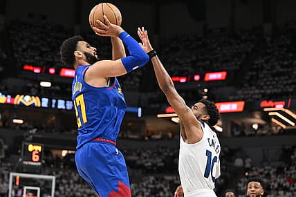Apr 21, 2023; Minneapolis, Minnesota, USA; Denver Nuggets guard Jamal Murray (27) is defended by Minnesota Timberwolves guard Mike Conley (10) during the second quarter of game three of the 2023 NBA Playoffs at Target Center. Mandatory Credit: Jeffrey Becker-USA TODAY Sports