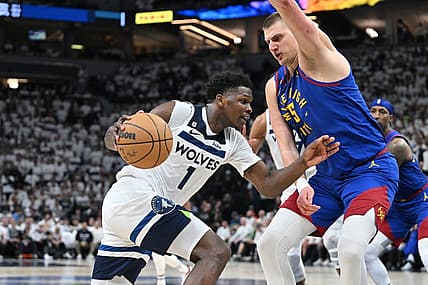 Apr 21, 2023; Minneapolis, Minnesota, USA; Minnesota Timberwolves guard Anthony Edwards (1) goes to the basket as Denver Nuggets center Nikola Jokic (15) defends during the fourth quarter of game three of the 2023 NBA Playoffs at Target Center. Mandatory Credit: Jeffrey Becker-USA TODAY Sports
