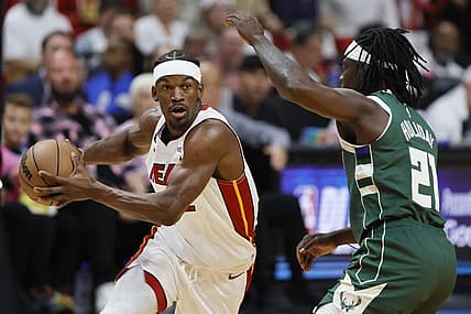 Apr 22, 2023; Miami, Florida, USA; Miami Heat forward Jimmy Butler (22) drives to the basket against Milwaukee Bucks guard Jrue Holiday (21) in the first quarter during game three of the 2023 NBA Playoffs at Kaseya Center. Mandatory Credit: Sam Navarro-USA TODAY Sports