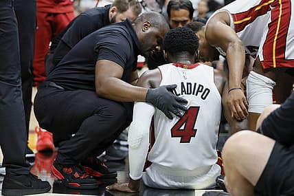 Apr 22, 2023; Miami, Florida, USA; Miami Heat guard Victor Oladipo (4) is checked on after an injury in the fourth quarter against the Milwaukee Bucks during game three of the 2023 NBA Playoffs at Kaseya Center. Mandatory Credit: Sam Navarro-USA TODAY Sports
