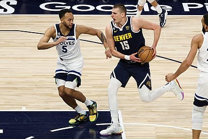 Apr 23, 2023; Minneapolis, Minnesota, USA; Denver Nuggets center Nikola Jokic (15) drives to the basket while Minnesota Timberwolves forward Kyle Anderson (5) defends during the first quarter of game four of the 2023 NBA Playoffs at Target Center. Mandatory Credit: Matt Krohn-USA TODAY Sports