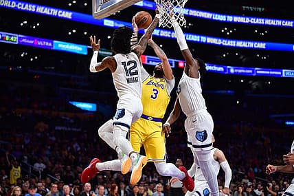 Apr 24, 2023; Los Angeles, California, USA; Los Angeles Lakers forward Anthony Davis (3) moves to the basket against Memphis Grizzlies guard Ja Morant (12) and forward Jaren Jackson Jr. (13) during the first half in game four of the 2023 NBA playoffs at Crypto.com Arena. Mandatory Credit: Gary A. Vasquez-USA TODAY Sports
