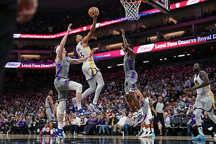 Apr 26, 2023; Sacramento, California, USA; Golden State Warriors guard Jordan Poole (3) makes a basket between Sacramento Kings guard Kevin Huerter (9) and guard De'Aaron Fox (5) in the third quarter during game five of the 2023 NBA playoffs at the Golden 1 Center. Mandatory Credit: Cary Edmondson-USA TODAY Sports