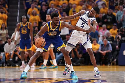 Apr 28, 2023; San Francisco, California, USA; Golden State Warriors forward Andrew Wiggins (22) dribbles the ball next to Sacramento Kings guard De'Aaron Fox (5) in the third quarter during game six of the 2023 NBA playoffs at the Chase Center. Mandatory Credit: Cary Edmondson-USA TODAY Sports