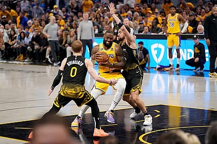 May 2, 2023; San Francisco, California, USA; Los Angeles Lakers forward LeBron James (6) drives to the hoop between Golden State Warriors guard Donte DiVincenzo (0) and guard Klay Thompson (11) in the second quarter during game one of the 2023 NBA playoffs at the Chase Center. Mandatory Credit: Cary Edmondson-USA TODAY Sports