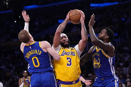 May 8, 2023; Los Angeles, California, USA; Los Angeles Lakers forward Anthony Davis (3) is defended by Golden State Warriors guard Donte DiVincenzo (0) and forward JaMychal Green (1) in the first half during game four of the 2023 NBA playoffs at Crypto.com Arena. Mandatory Credit: Kirby Lee-USA TODAY Sports