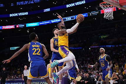 May 8, 2023; Los Angeles, California, USA; Los Angeles Lakers forward LeBron James (6) shoots the ball against Golden State Warriors forward Andrew Wiggins (22) and guard Klay Thompson (11) during game four of the 2023 NBA playoffs at Crypto.com Arena. Mandatory Credit: Kirby Lee-USA TODAY Sports