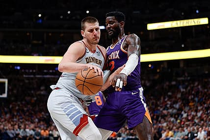 May 9, 2023; Denver, Colorado, USA; Denver Nuggets center Nikola Jokic (15) controls the ball as Phoenix Suns center Deandre Ayton (22) defends in the fourth quarter during game five of the 2023 NBA playoffs at Ball Arena. Mandatory Credit: Isaiah J. Downing-USA TODAY Sports