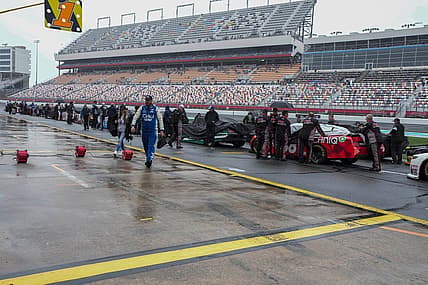May 29, 2023; Concord, North Carolina, USA; Cars are pushed back to the garage area after NASCAR cancels the Alsco Uniforms 300 at Charlotte Motor Speedway. Mandatory Credit: Jim Dedmon-USA TODAY Sports