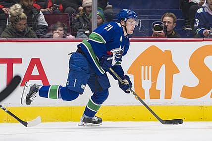 Nov 29, 2022; Vancouver, British Columbia, CAN; Vancouver Canucks forward Nils Hoglander (21) handles the puck  against the Washington Capitals in the third period at Rogers Arena. Washington won 5-1. Mandatory Credit: Bob Frid-USA TODAY Sports